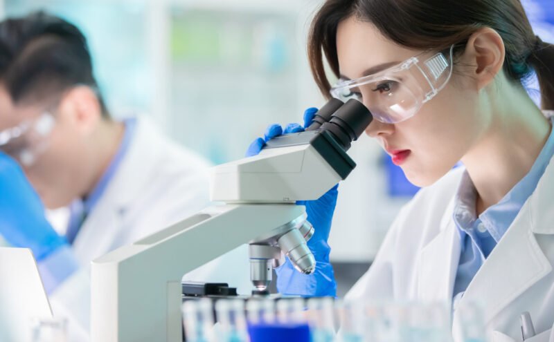Asian scientist use microscope close up of asian female scientist use microscope in the laboratory